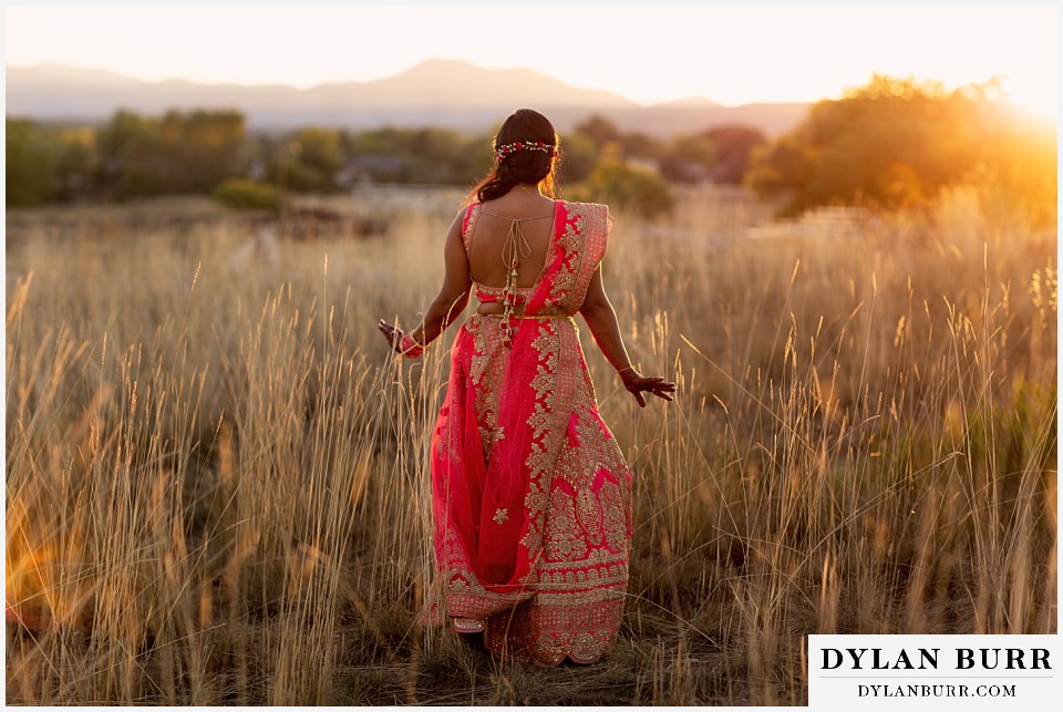 lakewood heritage center mehndi hindu wedding mehndi bride standing in field at sunset