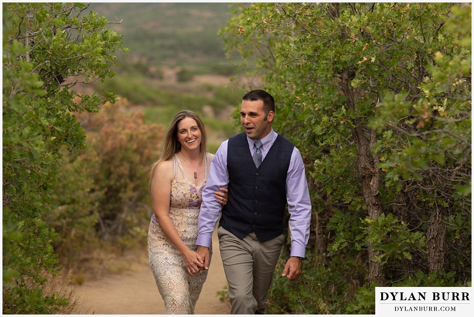 black canyon colorado elopement wedding adventure bride and groom walking together in scrub gambel oak trees.