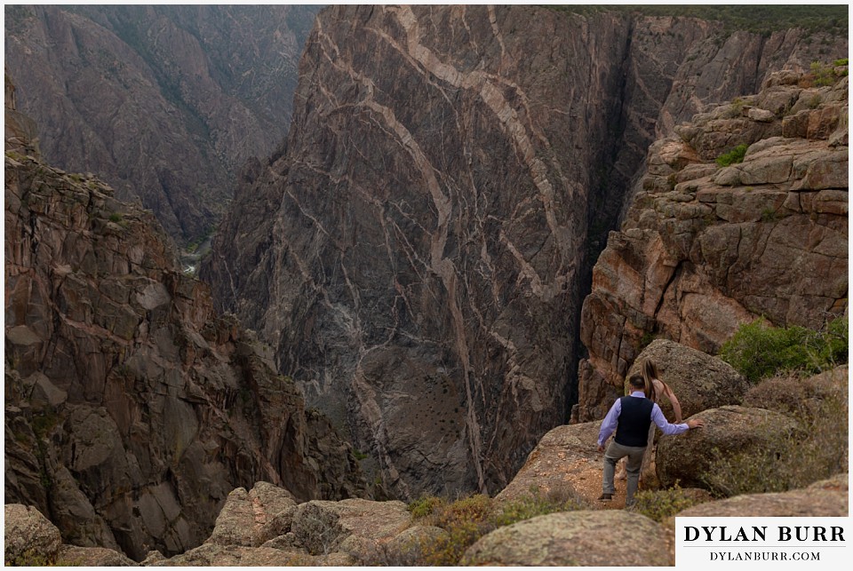 black canyon colorado elopement wedding adventure bride and groom walking down to painted wall view