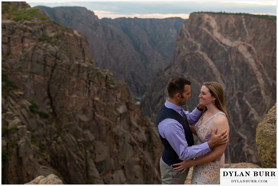 black canyon colorado elopement wedding adventure bride and groom share a moment near the painted wall at sunset