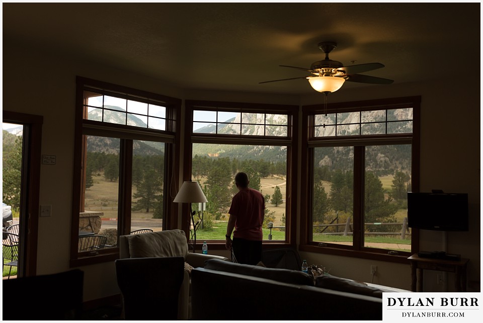 black canyon inn wedding estes park colorado looking out a window at mountains