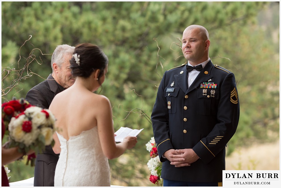 black canyon inn wedding estes park colorado groom listening to his bride give her vows