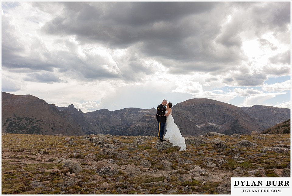 rocky mountain national park wedding colorado bride and groom kissing on top of mountain range