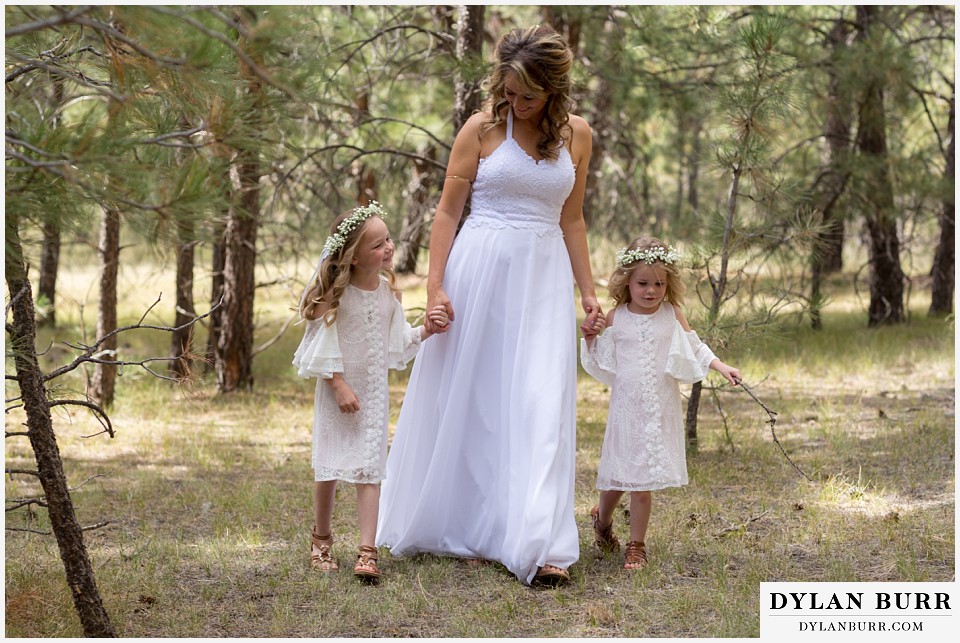 boho backyard colorado wedding bride walking holding daughters hands