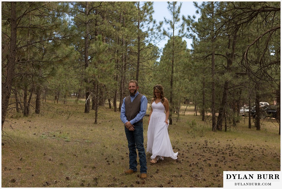 boho backyard colorado wedding bride walking up to groom for the first look