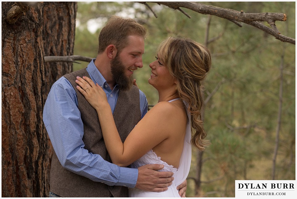 boho backyard colorado wedding bride and groom near pine tree