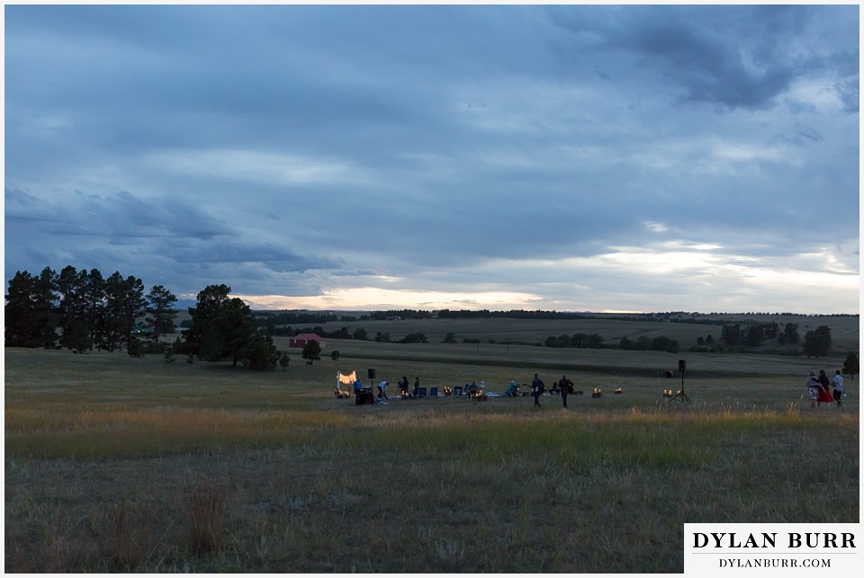 boho backyard colorado wedding ceremony as dusk approaches