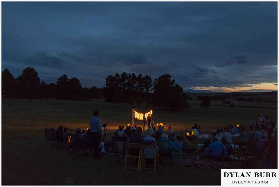 boho backyard colorado wedding ceremony site in a meadow at dusk