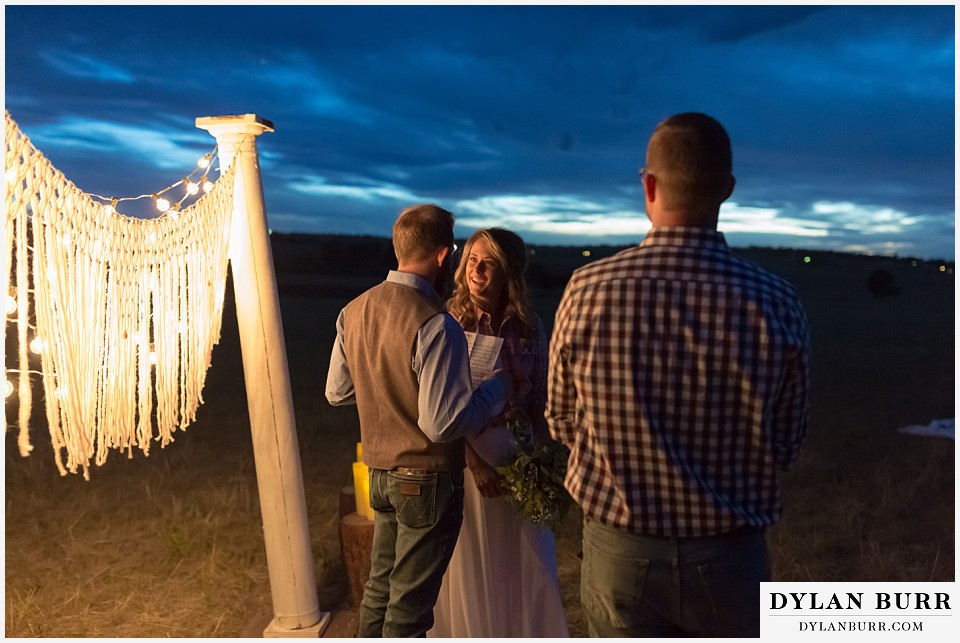 boho backyard colorado wedding bride and groom exchanging vows