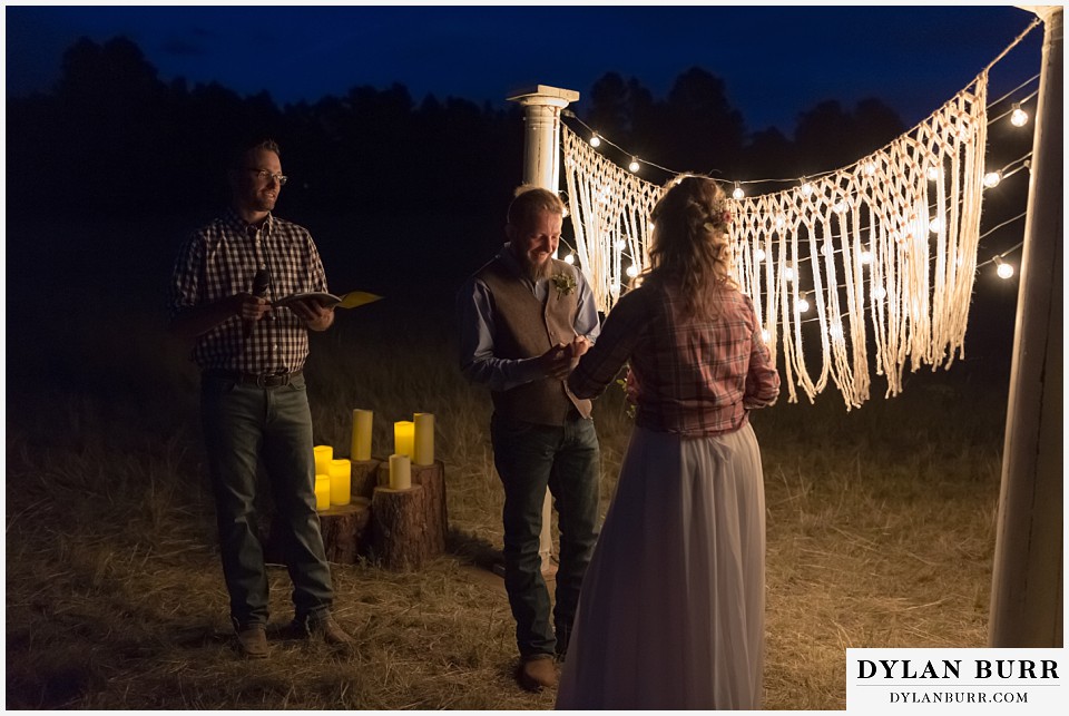 boho backyard colorado wedding groom giving his vows to his bride