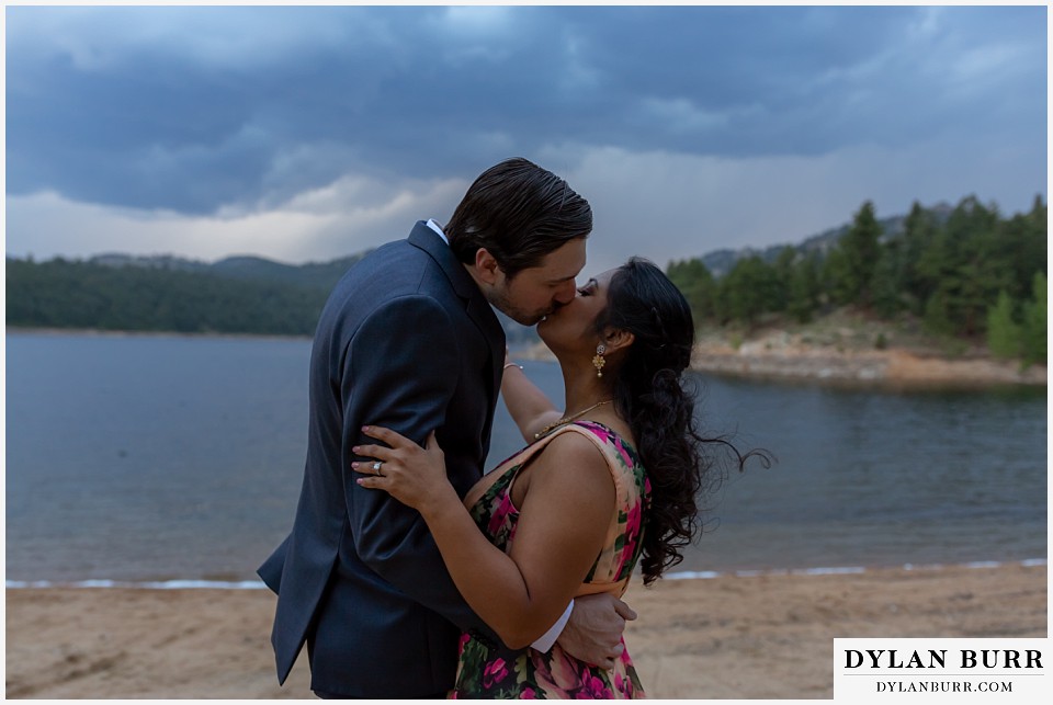 boulder colorado engagement session in the mountains couple kissing by lake