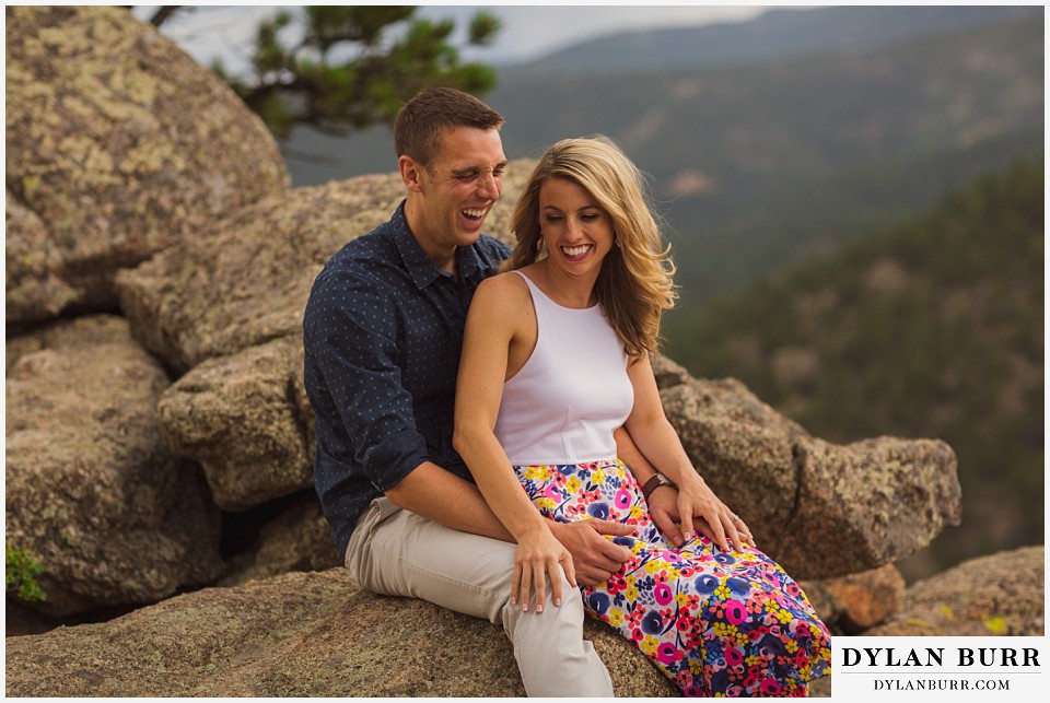 boulder sunset engagement session laughing on rock