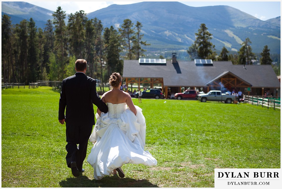 breckenridge 4wd adventure wedding couple running in field back to reception