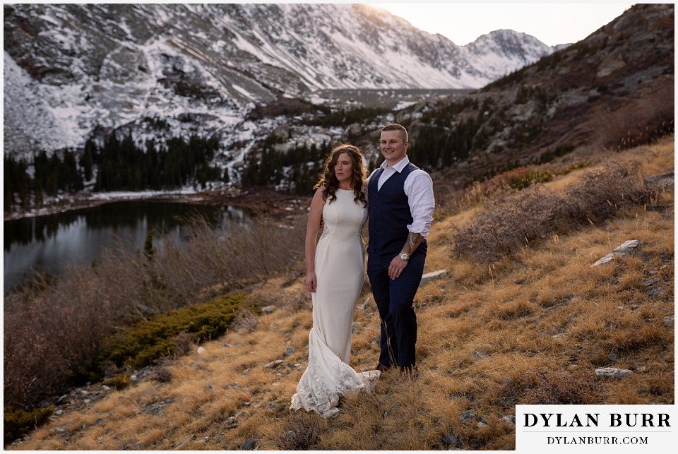 breckenridge mountain wedding couple near snowy mountains at sunset