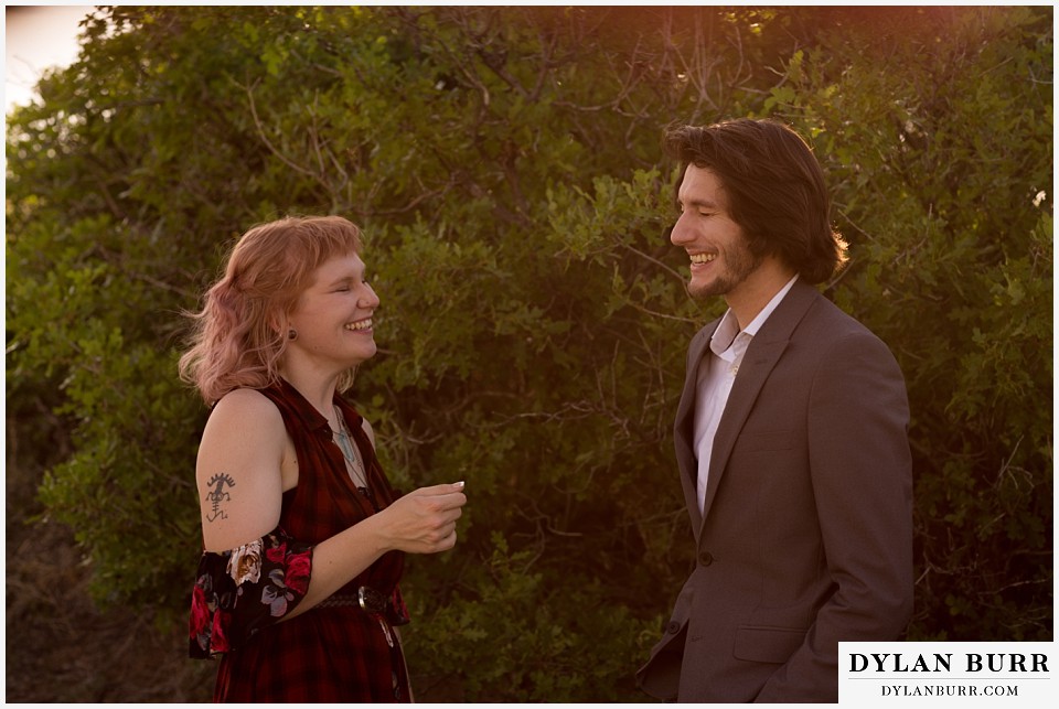 castle rock colorado engagement session lauging with sunset glow in trees