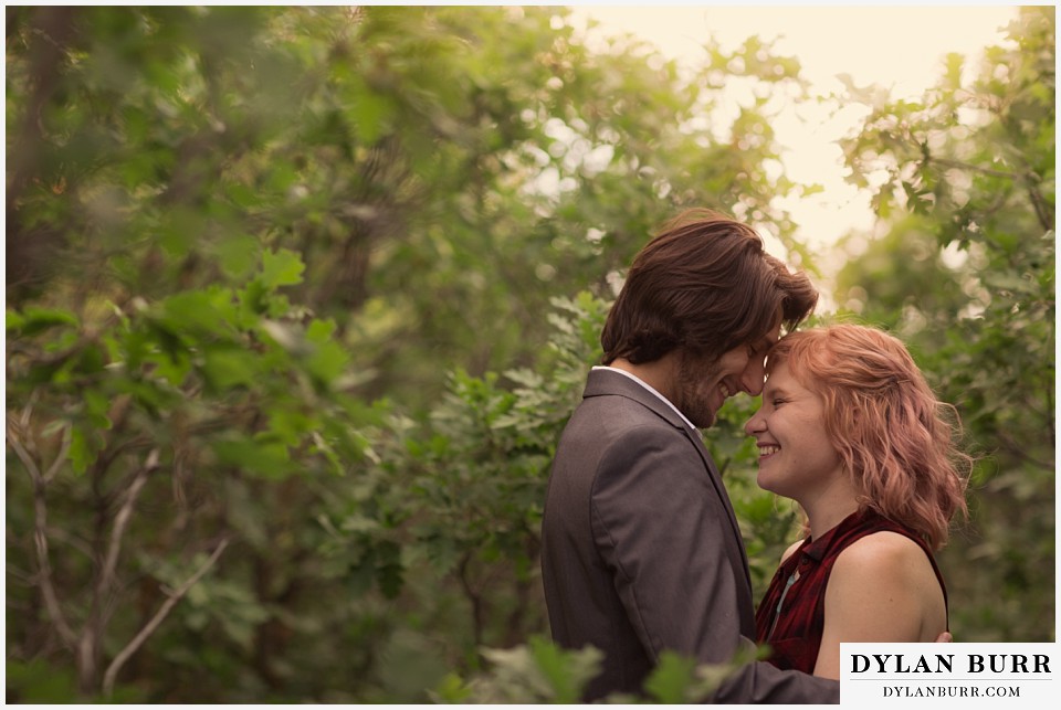 castle rock colorado engagement session snuggles at sunset in oak trees