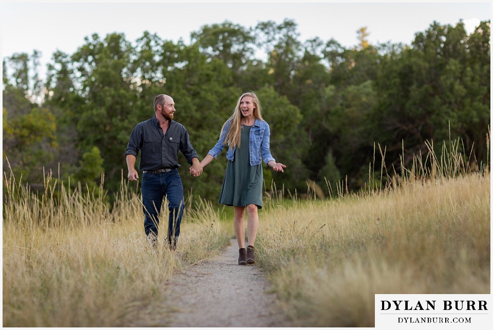 castlewood canyon engagement photos couple walking along trail