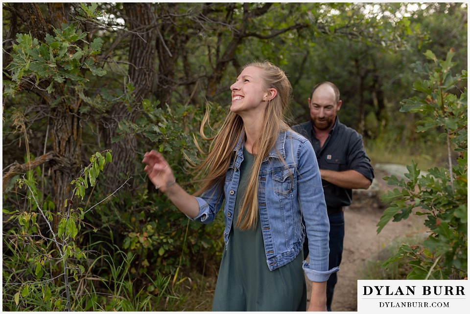 castlewood canyon engagement photos she's laughing while walking together