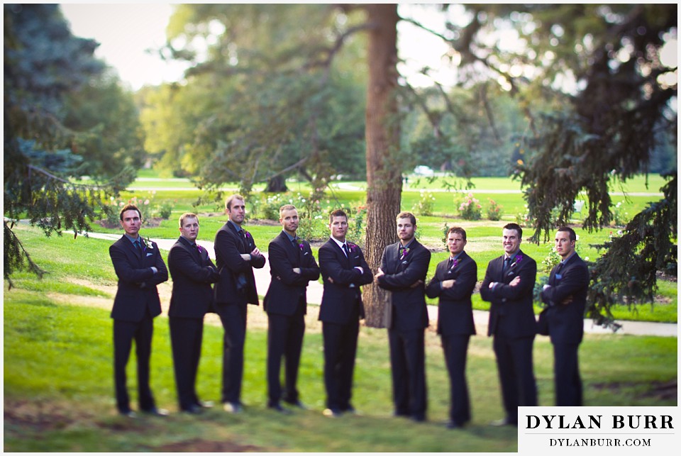 cheesman park pavilion wedding groomsmen and groom near pine trees