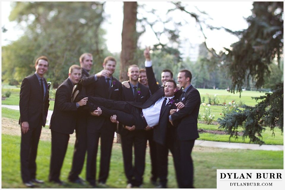cheesman park pavilion wedding groomsmen lifting up groom