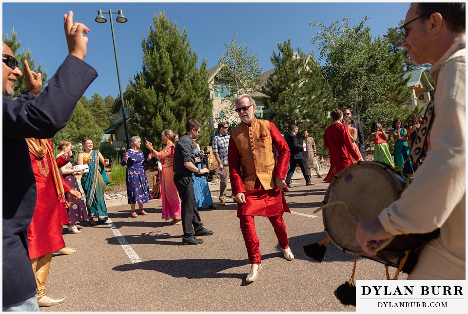 cielo at castle pines wedding colorado mountain wedding father of groom dancing during barat hindu wedding