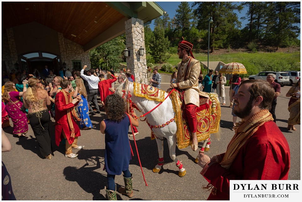 cielo at castle pines wedding colorado mountain wedding groom riding into hindu ceremony