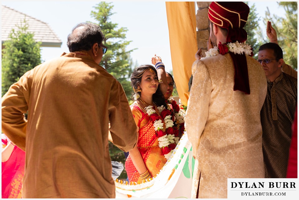 cielo at castle pines wedding colorado mountain wedding bride looks on at groom hindu wedding ceremony
