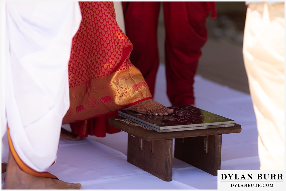 cielo at castle pines wedding colorado mountain wedding bride stepping on platform hindu ceremony