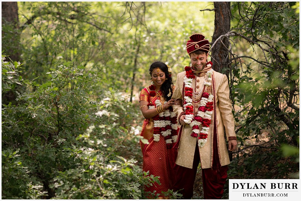 cielo at castle pines wedding colorado mountain wedding bride and groom walking through forest