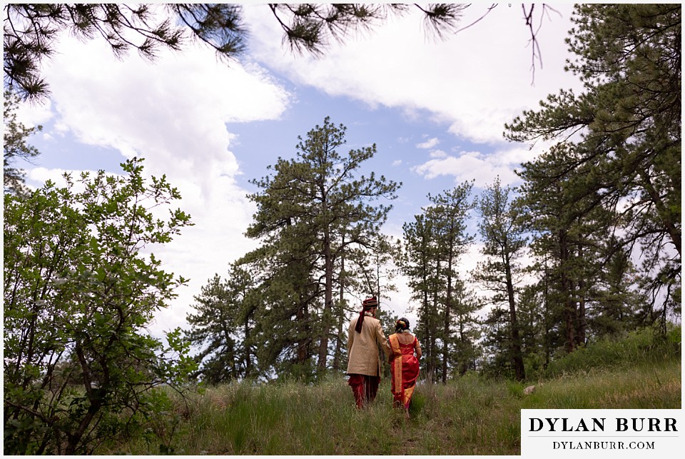 cielo at castle pines wedding colorado mountain wedding hindu wedding newlyweds walking together up hill