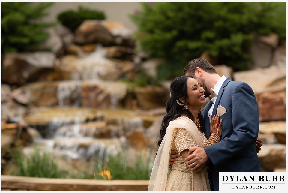 cielo at castle pines wedding colorado mountain wedding groom saying something funny to hindu bride