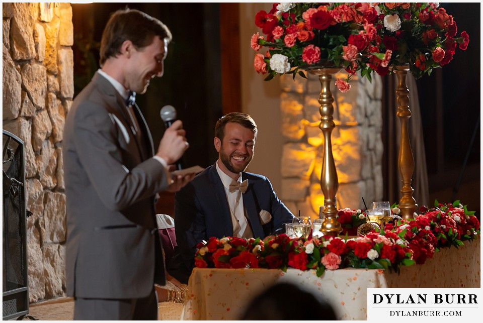 cielo at castle pines wedding colorado mountain wedding groom laughing during best man speech