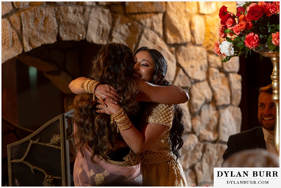cielo at castle pines wedding colorado mountain wedding hindu bride hugging maid of honor