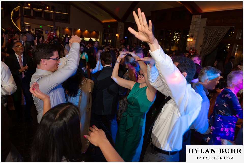 cielo at castle pines wedding colorado mountain wedding hands up dancing