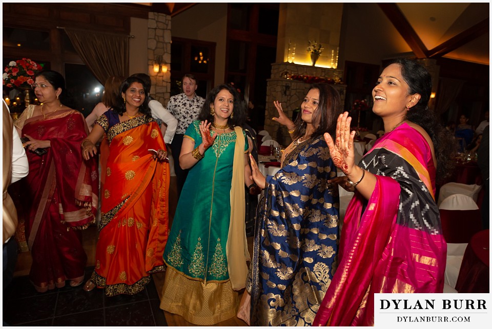 cielo at castle pines wedding colorado mountain wedding bright colorful dresses on dance floor hindu wedding