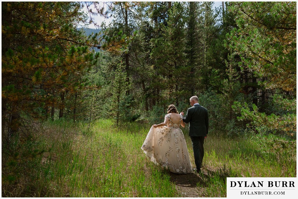 clinton gulch micro wedding walking hand in hand into the forest