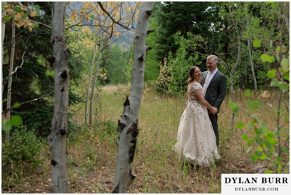 clinton gulch micro wedding laughing together in the aspen trees in early fall
