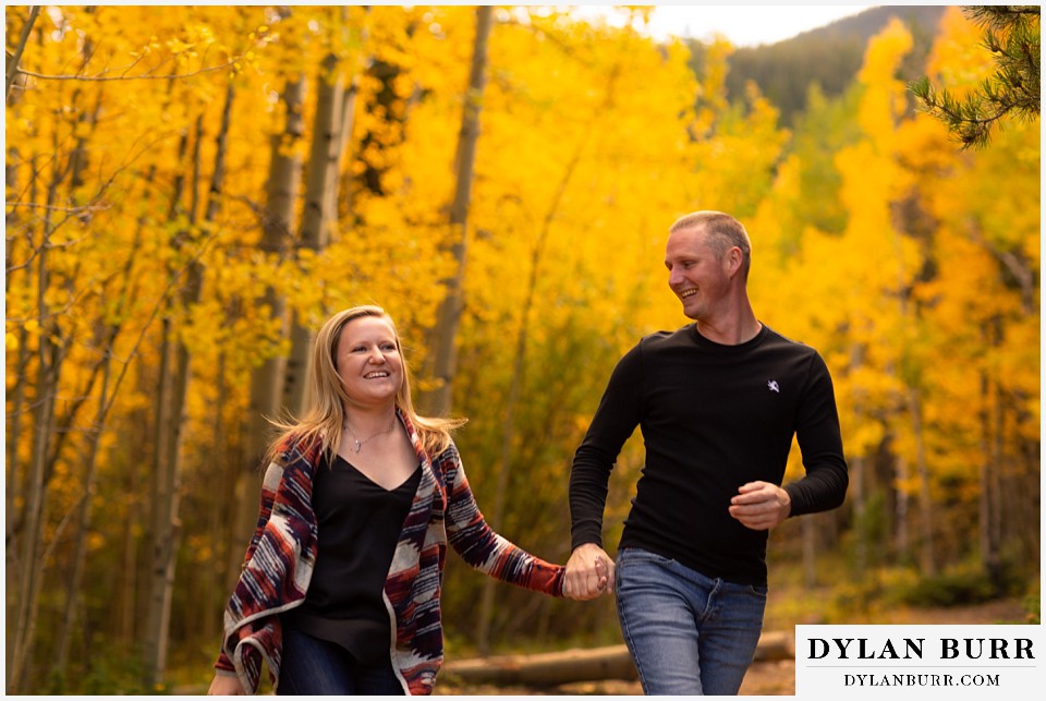 engagement photos in colorado couple smiling in mountains