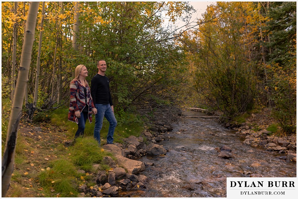 engagement photos in colorado couple near a small creek