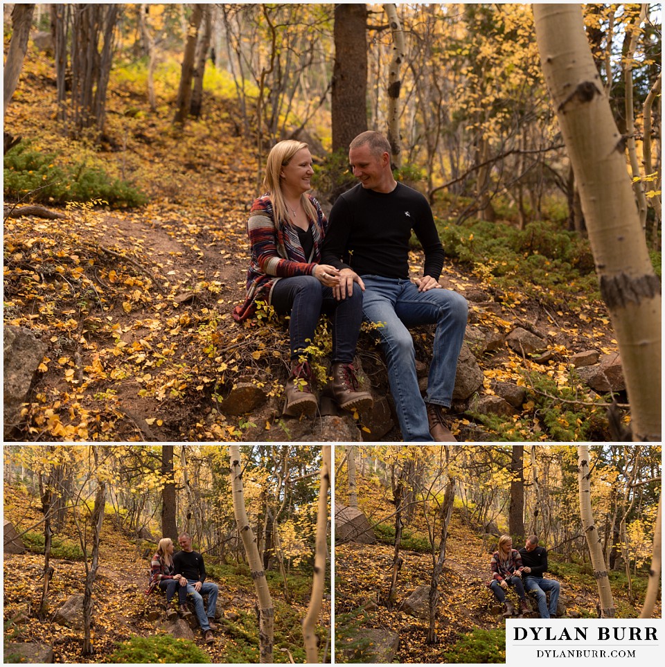engagement photos in colorado couple taking a minute to sit on a large rock in forest