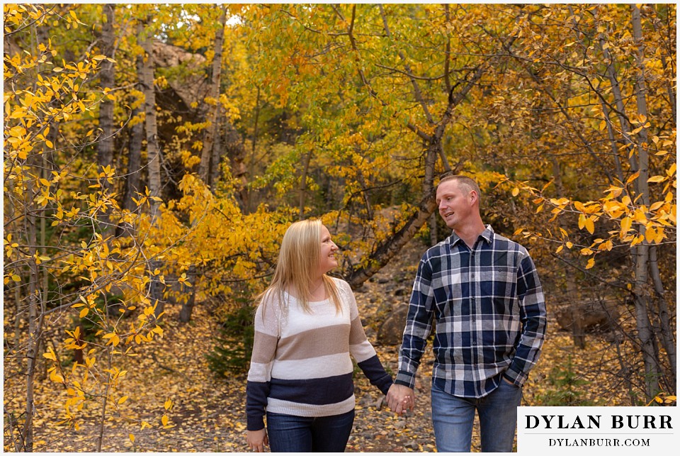 engagement photos in colorado couple walking together