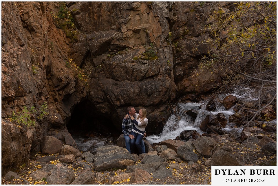 engagement photos in colorado river dissapears behind couple and goes through rock