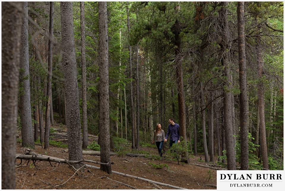 colorado mountain enagagement photo session walking in forest together