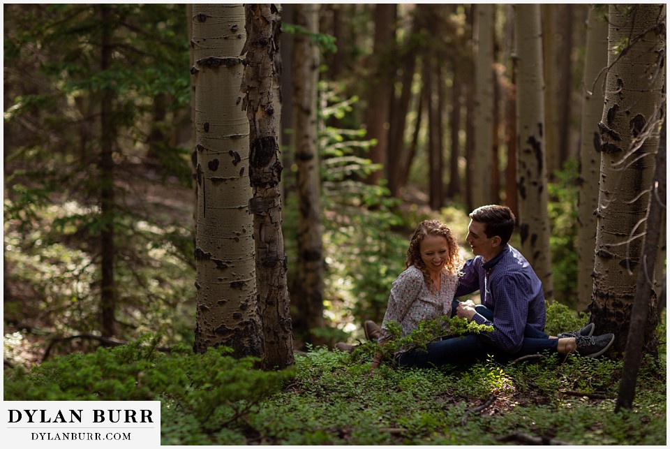 colorado mountain enagagement photo session laughing together in forest