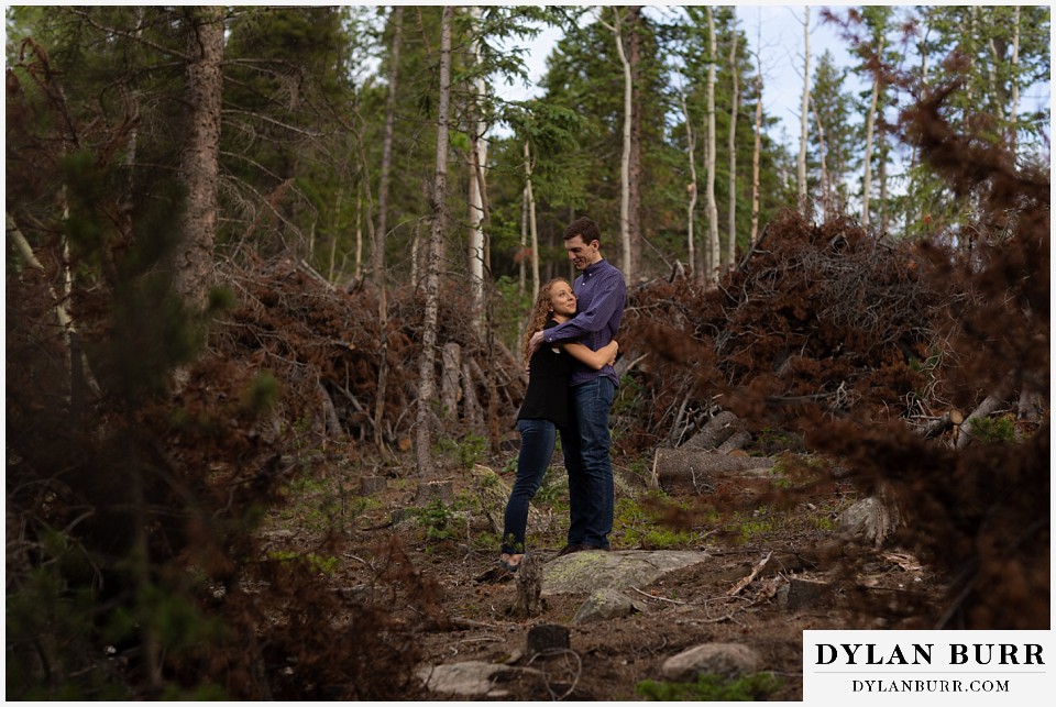 colorado mountain enagagement photo session couple within stacks of pine trees