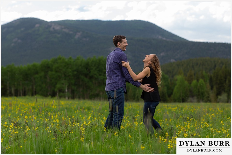 colorado mountain enagagement photo session laughing and having fun in a meadow