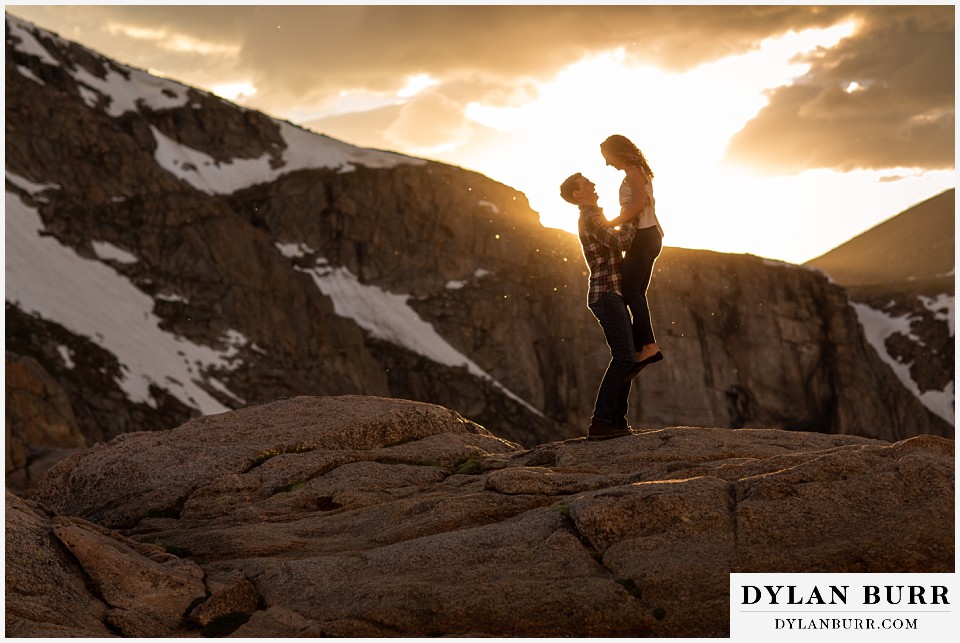 colorado mountain enagagement photo session lifing fiance high up
