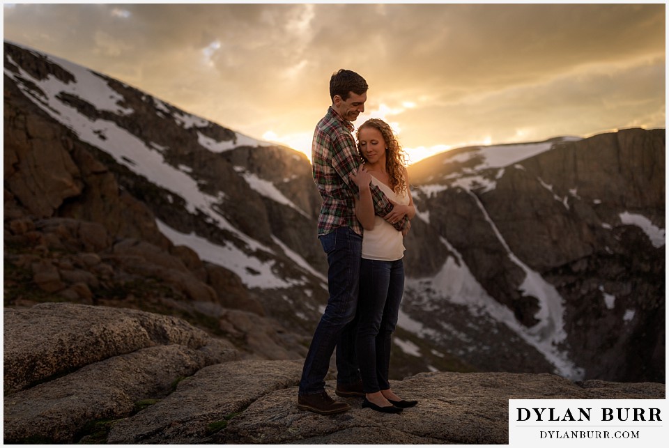 colorado mountain enagagement photo session standing on snow capped mountain peak