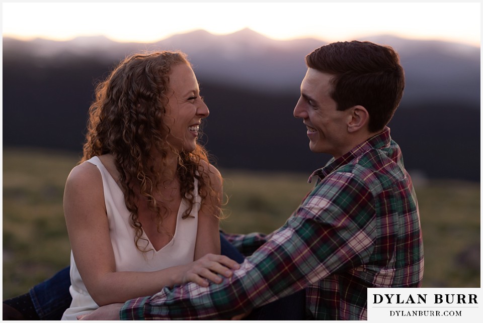 colorado mountain enagagement photo session couple laughing together in mountains