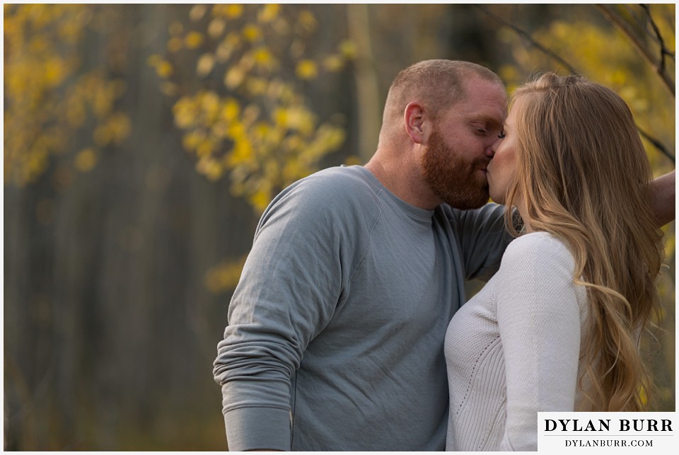 colorado mountain engagement session kissing in the aspens